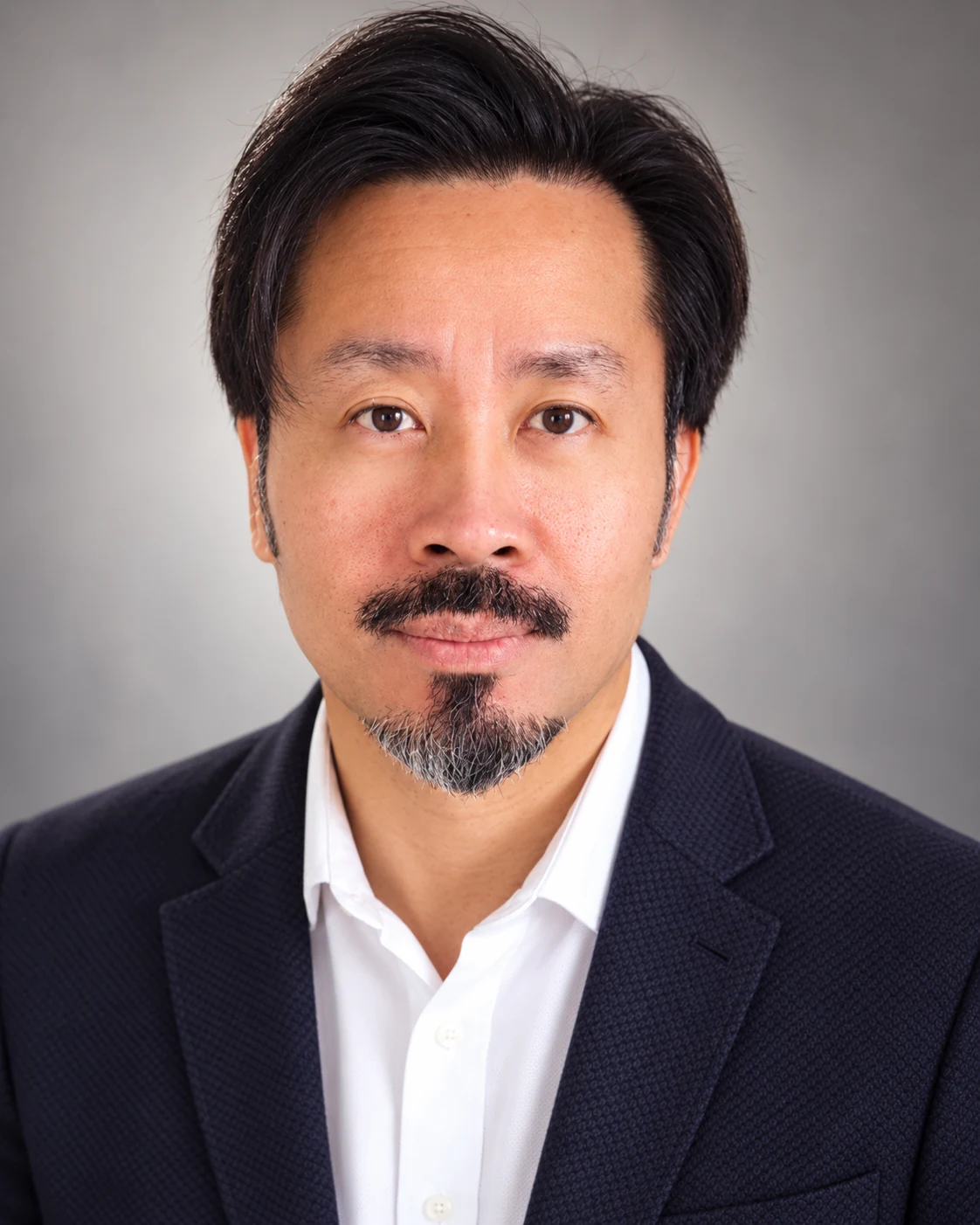 Marvin Fernandez professional headshot in a dark navy jacket and white shirt