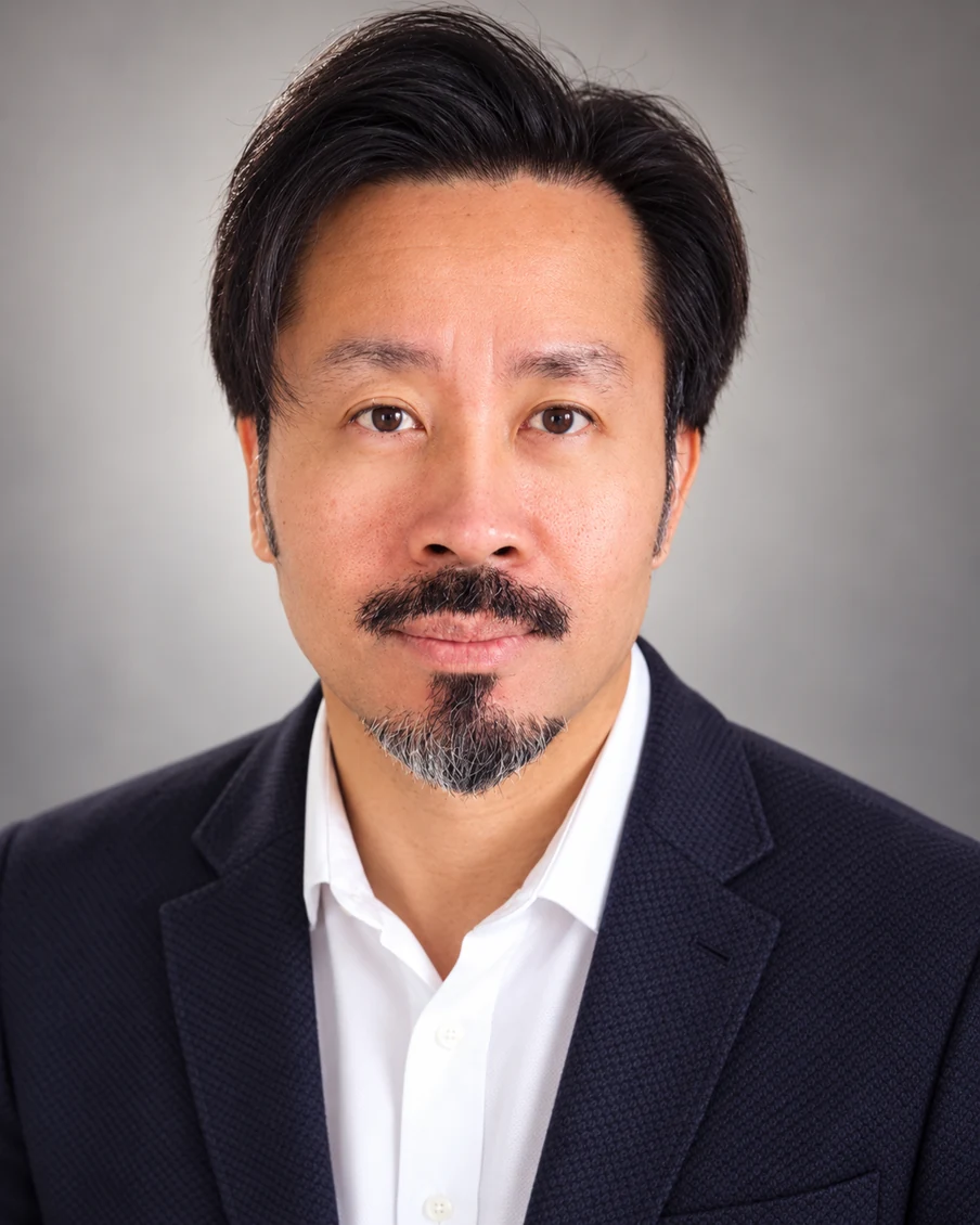 Marvin Fernandez biography portrait in a dark jacket and white shirt