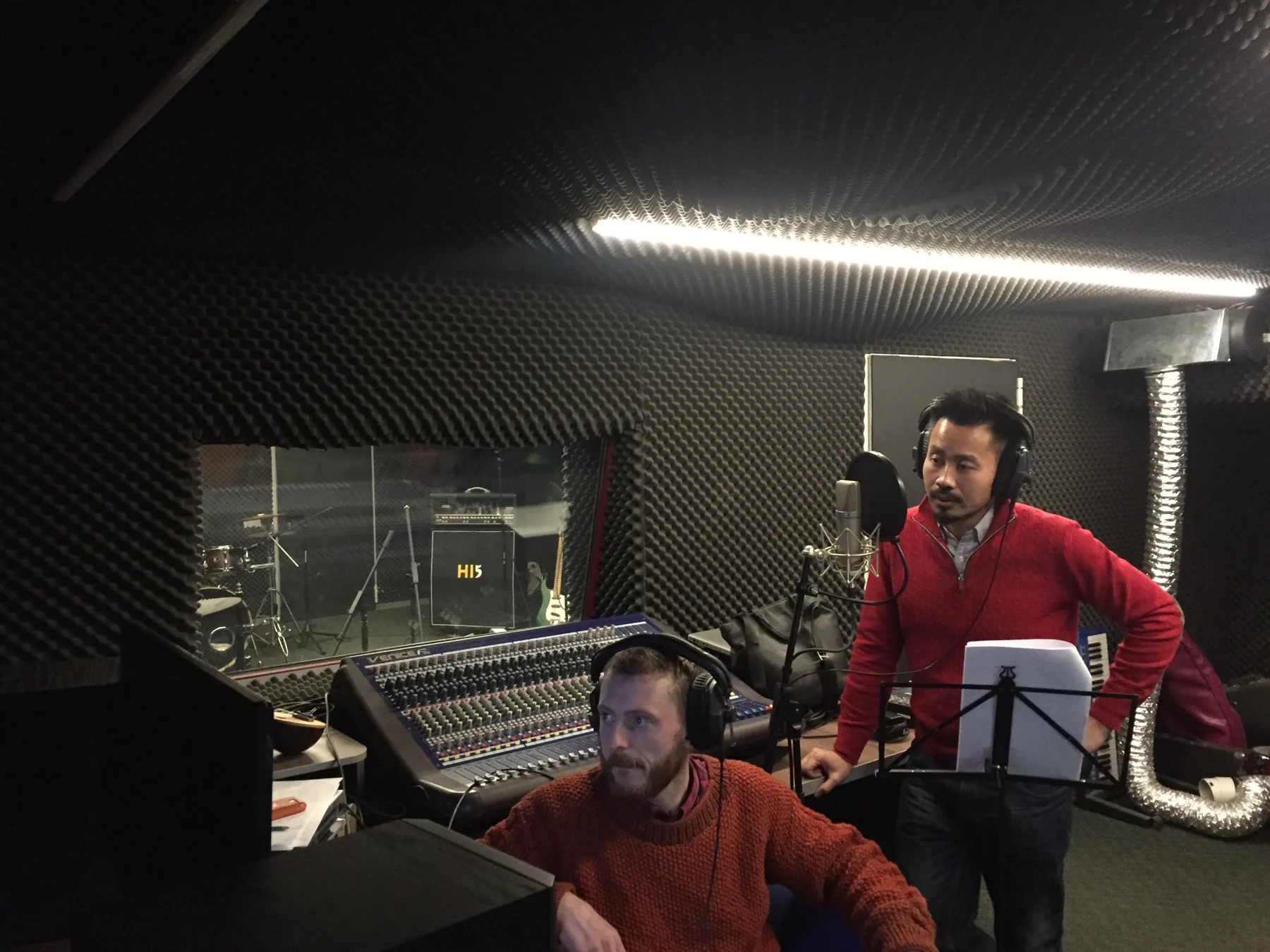 Marvin Fernandez holding a script during a voice-over recording session